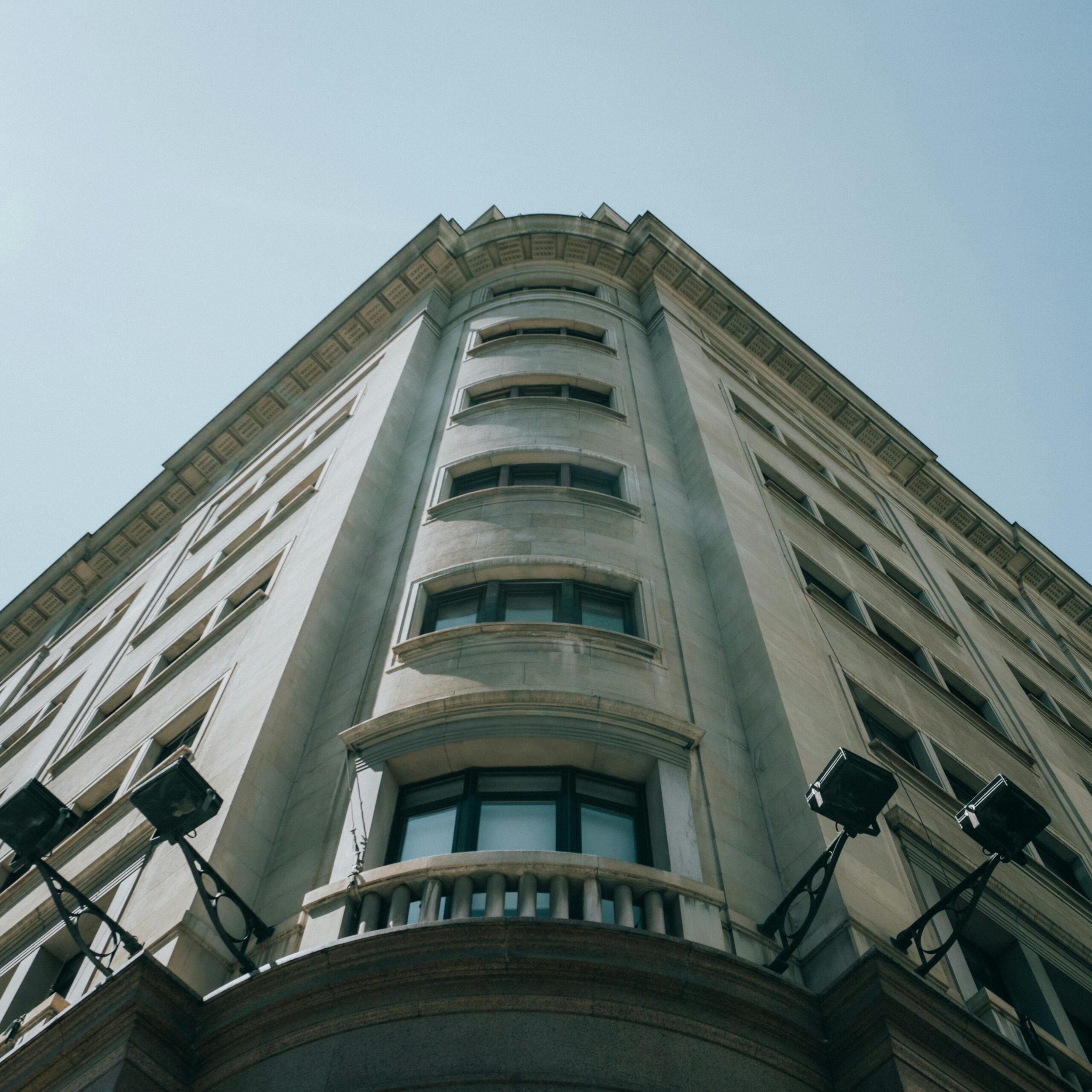 A striking low-angle view of a classic building in Madrid, capturing its architectural details.
